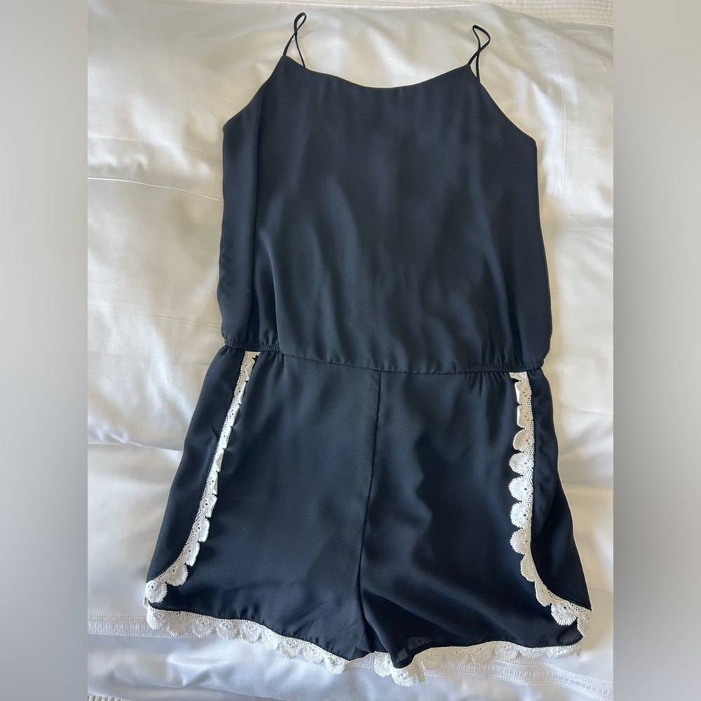 AQUA black romper with white lace trim. Size large. Spaghetti strap. Adorable!
